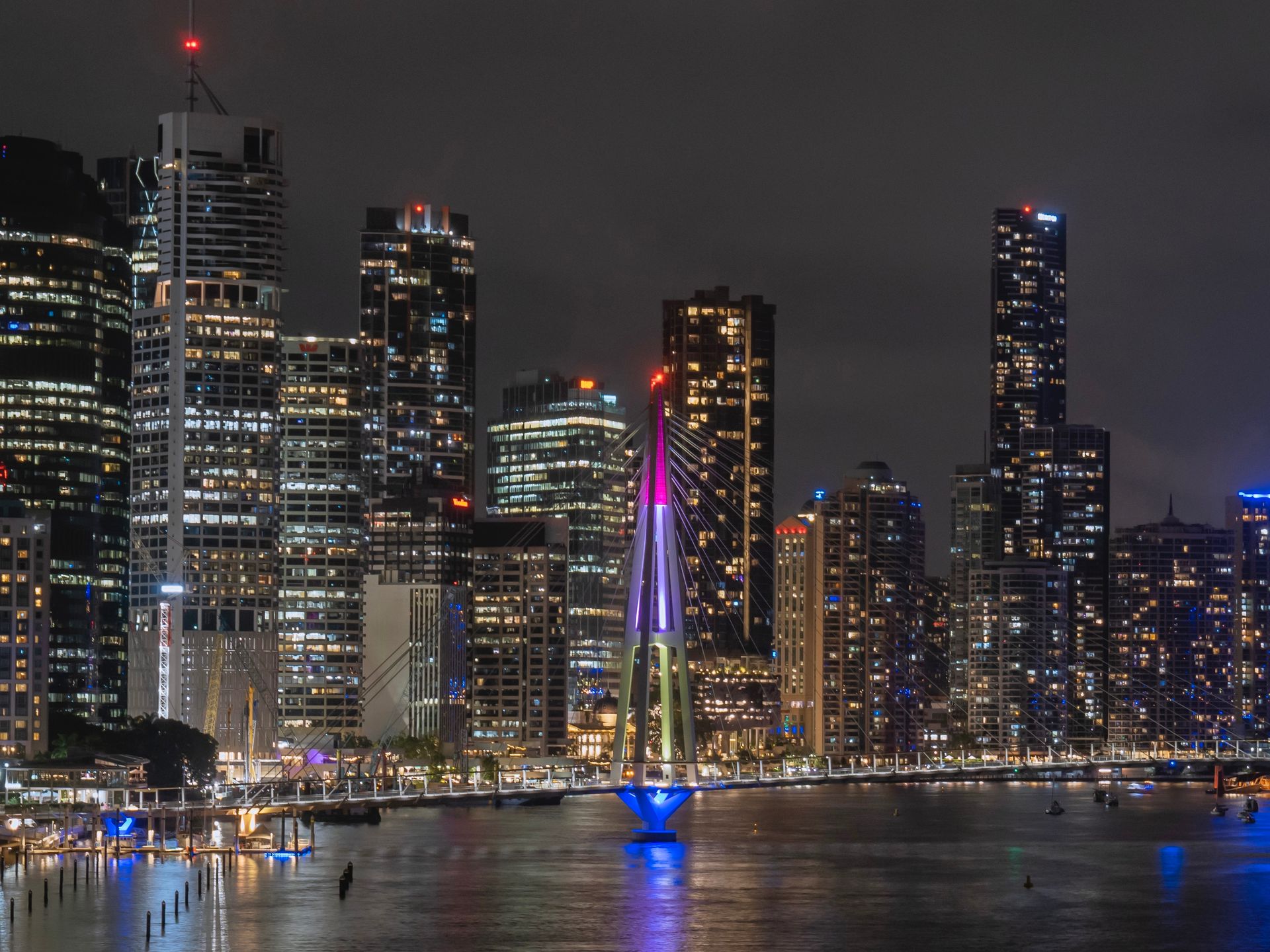 Brisbane riverfront and illuminated bridge at night